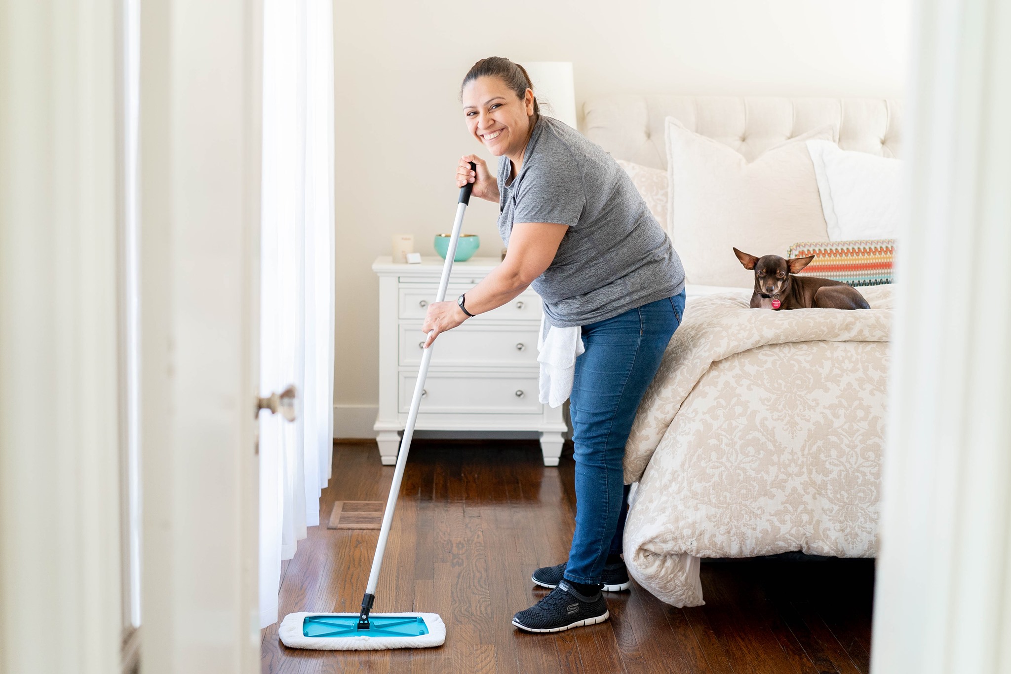 Professional Cleaner sweeping a bedroom floor