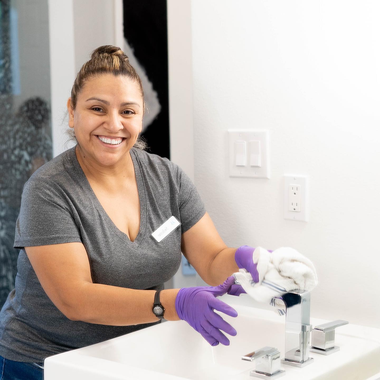 HPH employee cleaning a bathroom sink in plano